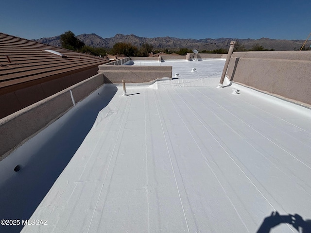 details featuring a flat roof and a mountain view