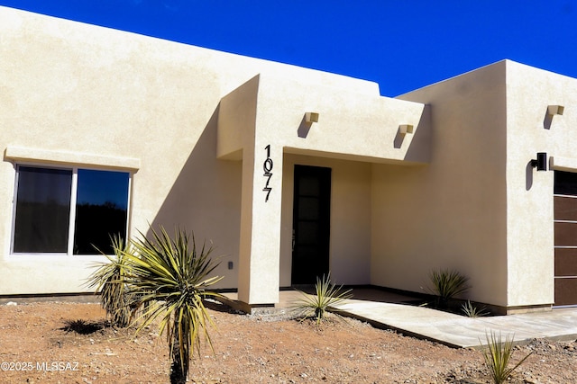 entrance to property with stucco siding