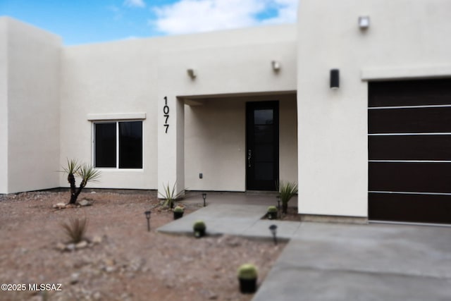 property entrance with stucco siding