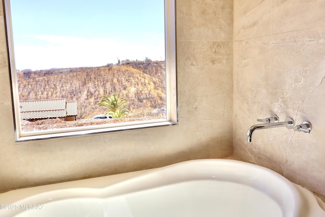 bathroom featuring a tub to relax in