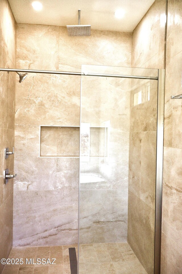 full bathroom with a tub with jets, a healthy amount of sunlight, and a mountain view