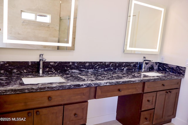 bathroom with a sink and double vanity