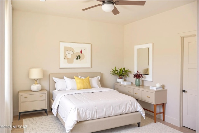 1077 Avenida Aire, Rio Rico, AZ 85648 - bedroom with wood finished floors, a ceiling fan, and baseboards