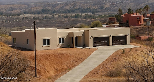 1077 Avenida Aire, Rio Rico, AZ 85648 - southwest-style home featuring stucco siding, concrete driveway, and a garage