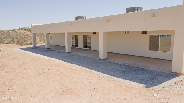 1077 Avenida Aire, Rio Rico, AZ 85648 - rear view of property featuring stucco siding, cooling unit, and a patio area