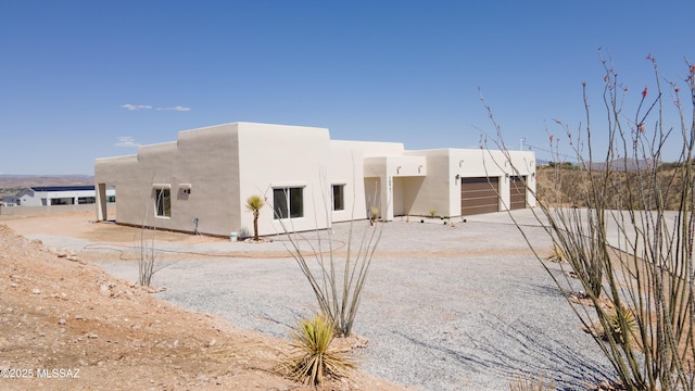 1077 Avenida Aire, Rio Rico, AZ 85648 - back of property featuring stucco siding, an attached garage, and driveway