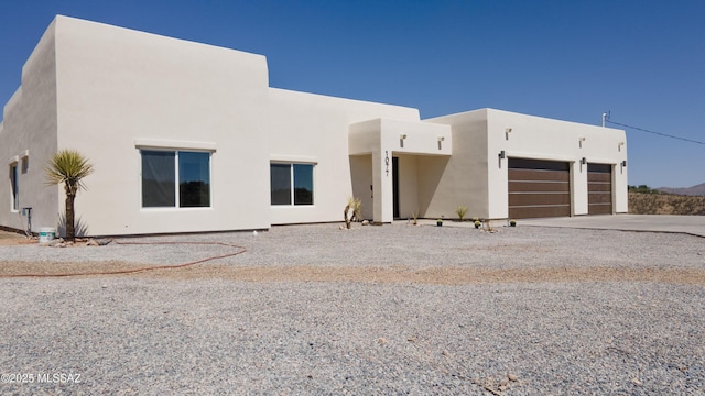 1077 Avenida Aire, Rio Rico, AZ 85648 - view of front of house with stucco siding, an attached garage, and concrete driveway