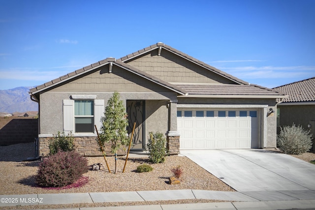 craftsman inspired home featuring stone siding, a tile roof, driveway, and stucco siding