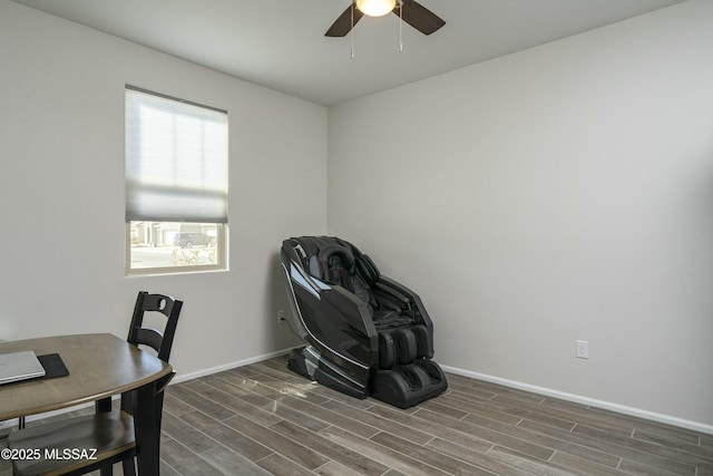 office with a ceiling fan, wood finish floors, and baseboards