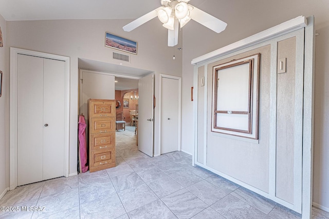 unfurnished bedroom featuring lofted ceiling, ceiling fan, visible vents, and a closet