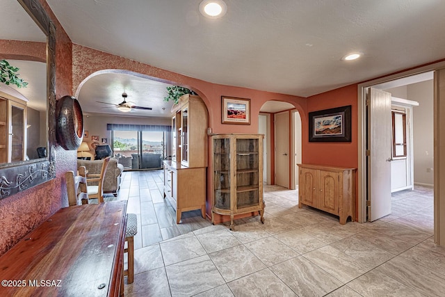 interior space with arched walkways and recessed lighting