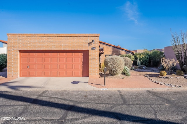 view of front facade featuring a garage and brick siding