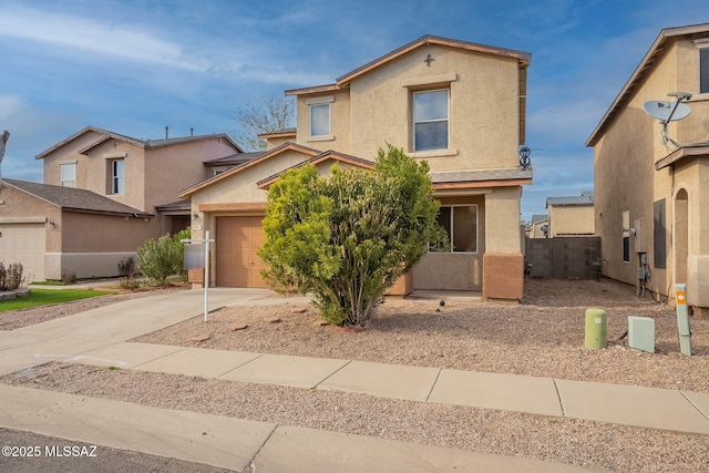 traditional-style home with driveway, fence, and stucco siding