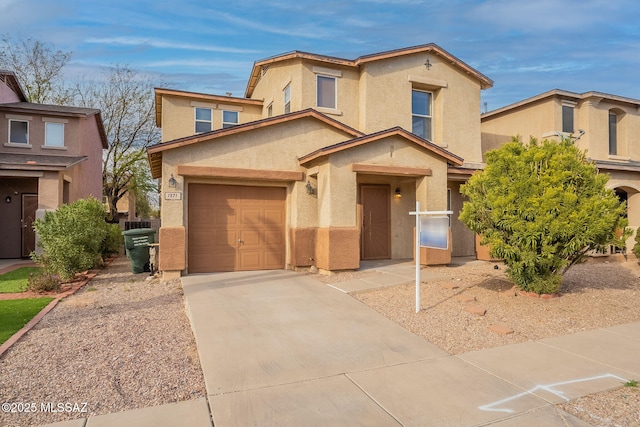 view of front of home with concrete driveway and stucco siding