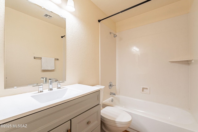 bathroom with visible vents, a textured wall, toilet, washtub / shower combination, and vanity