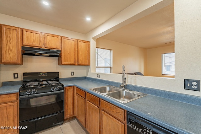 kitchen featuring plenty of natural light, a sink, under cabinet range hood, and black appliances