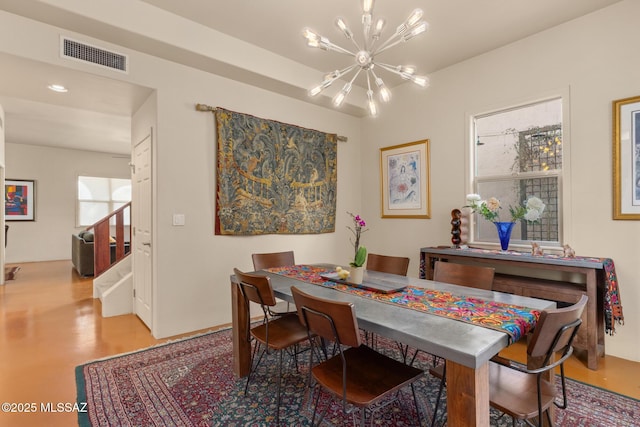 dining area featuring stairs, visible vents, and a notable chandelier