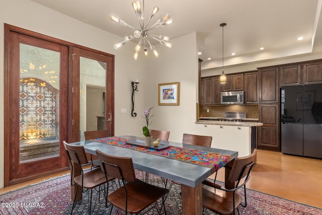 dining space with a chandelier and recessed lighting