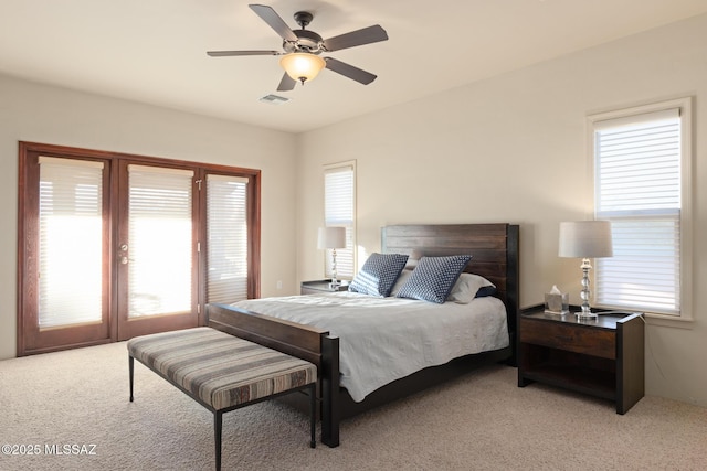 bedroom with ceiling fan, access to outside, visible vents, and light colored carpet