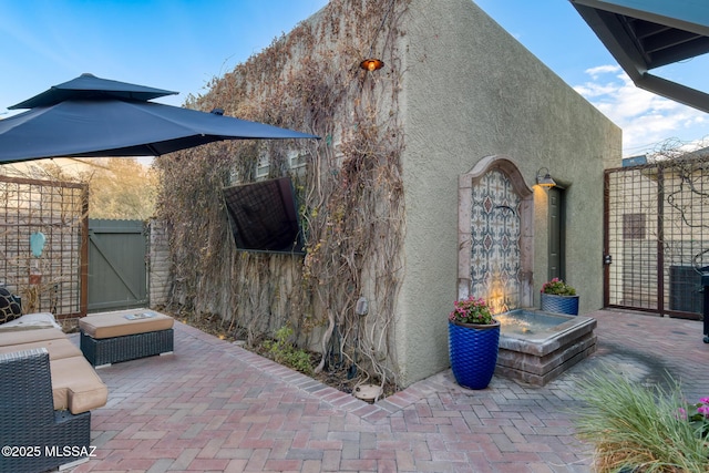 view of patio / terrace with fence and a gate