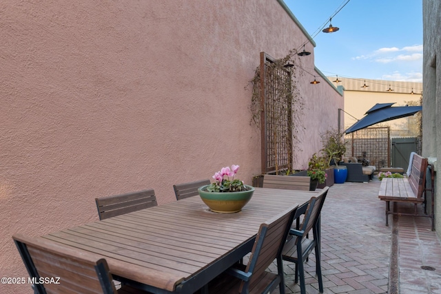 view of patio with outdoor dining space and fence