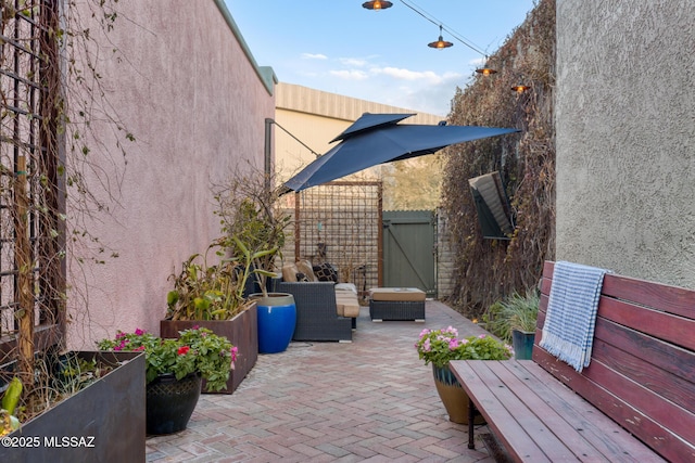 view of patio with a gate, fence, and an outdoor hangout area