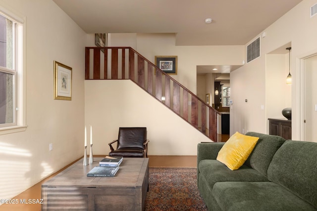 living room with stairway and visible vents