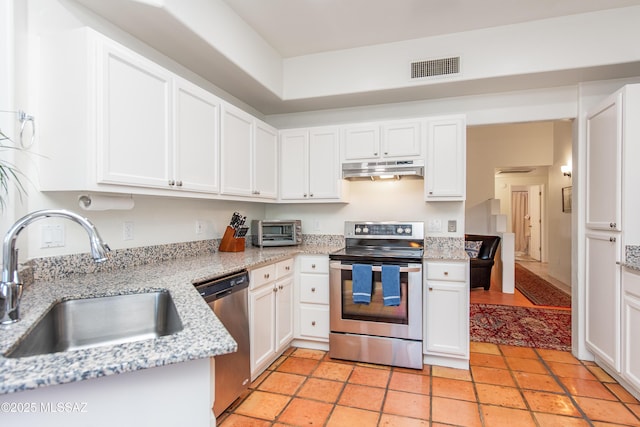 kitchen featuring visible vents, white cabinets, appliances with stainless steel finishes, under cabinet range hood, and a sink