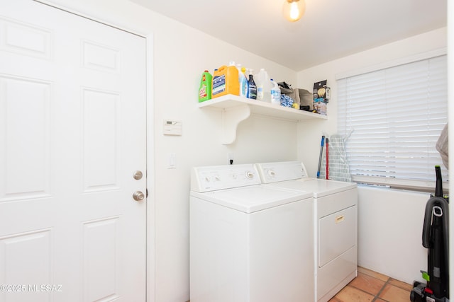 laundry room with laundry area, light tile patterned flooring, and washer and clothes dryer