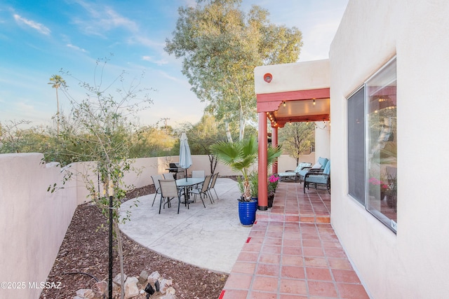 view of patio with a fenced backyard and outdoor dining area