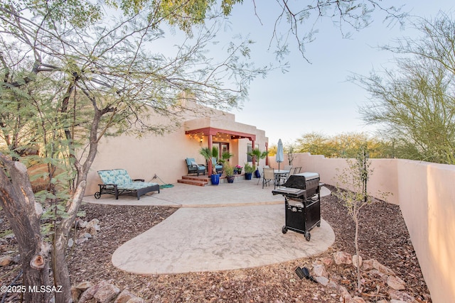 view of patio with fence and area for grilling