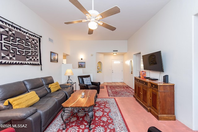 living area with ceiling fan and visible vents