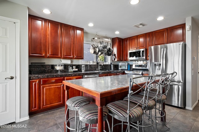 kitchen with a breakfast bar, visible vents, stainless steel appliances, and recessed lighting