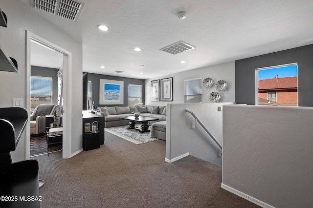 carpeted living room with baseboards, visible vents, and recessed lighting