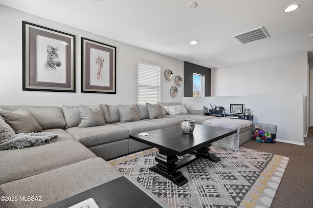 carpeted living room with baseboards, visible vents, and recessed lighting