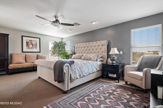 carpeted bedroom featuring visible vents and a ceiling fan