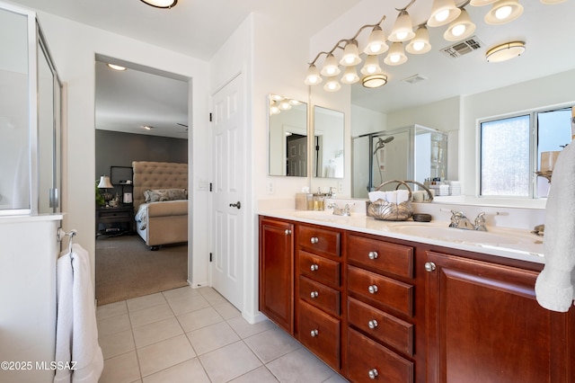 ensuite bathroom with ensuite bathroom, a sink, visible vents, a shower stall, and tile patterned floors