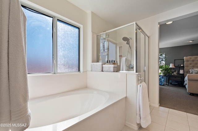 ensuite bathroom with a stall shower, tile patterned flooring, a garden tub, and ensuite bath