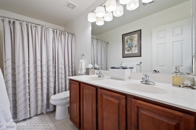 bathroom with tile patterned flooring, visible vents, a sink, and double vanity