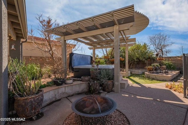 view of patio with a fire pit, a hot tub, fence, and a pergola