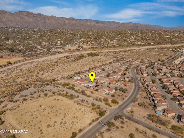 birds eye view of property featuring a mountain view and view of desert