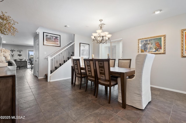 dining space featuring baseboards, stairs, and a chandelier