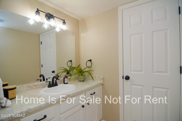 bathroom with visible vents and vanity