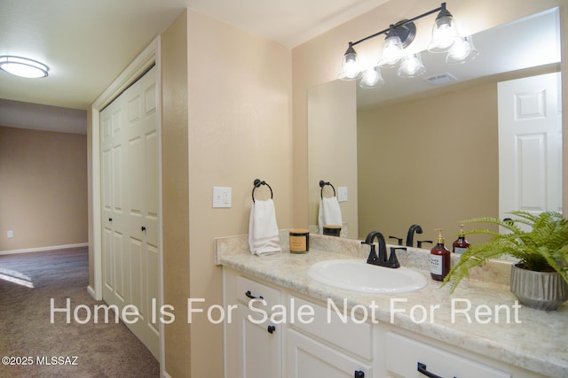 bathroom featuring baseboards, visible vents, a closet, and vanity