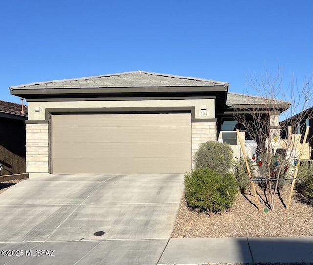 view of front facade featuring a garage, stone siding, and concrete driveway