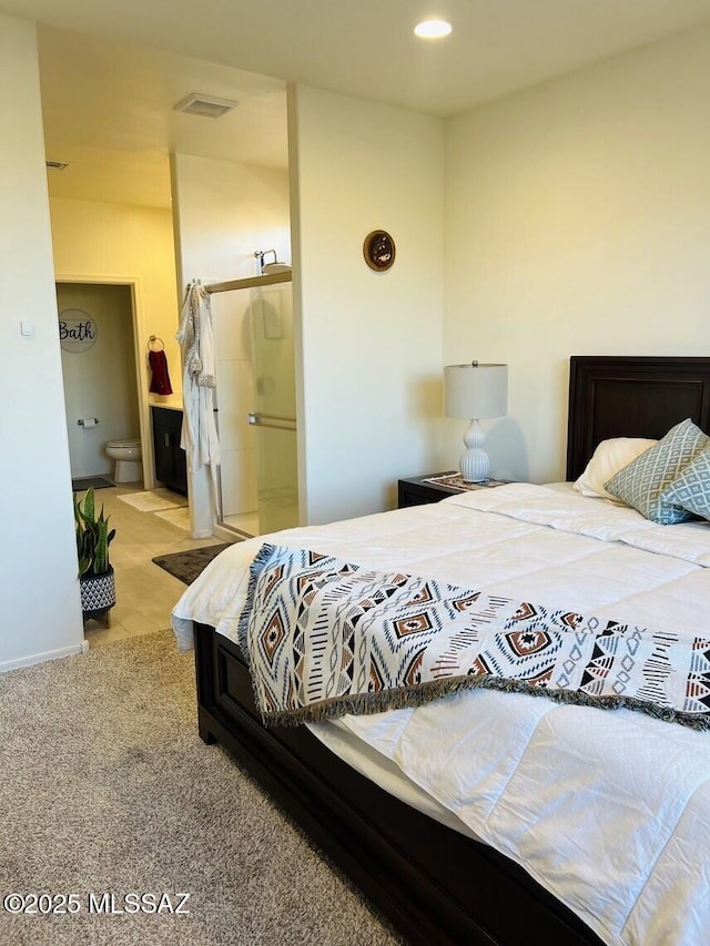 carpeted bedroom with recessed lighting, visible vents, and ensuite bathroom