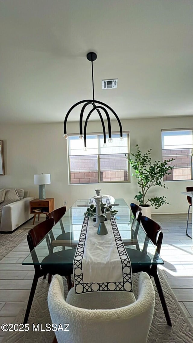 interior space with wood finished floors and visible vents