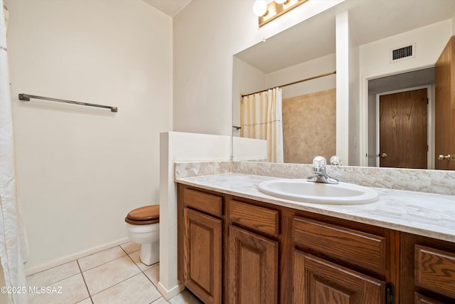 bathroom with visible vents, toilet, vanity, baseboards, and tile patterned floors