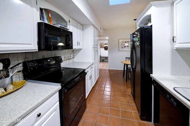 kitchen featuring tasteful backsplash, light countertops, white cabinetry, tile patterned flooring, and black appliances