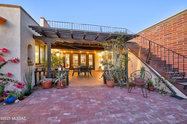 view of patio with outdoor dining area, stairway, and a pergola